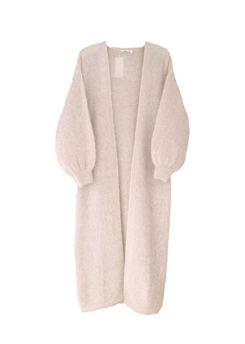 A beige mohair cardigan with long sleeves and a V-neck design, designed to be worn over other clothing items.