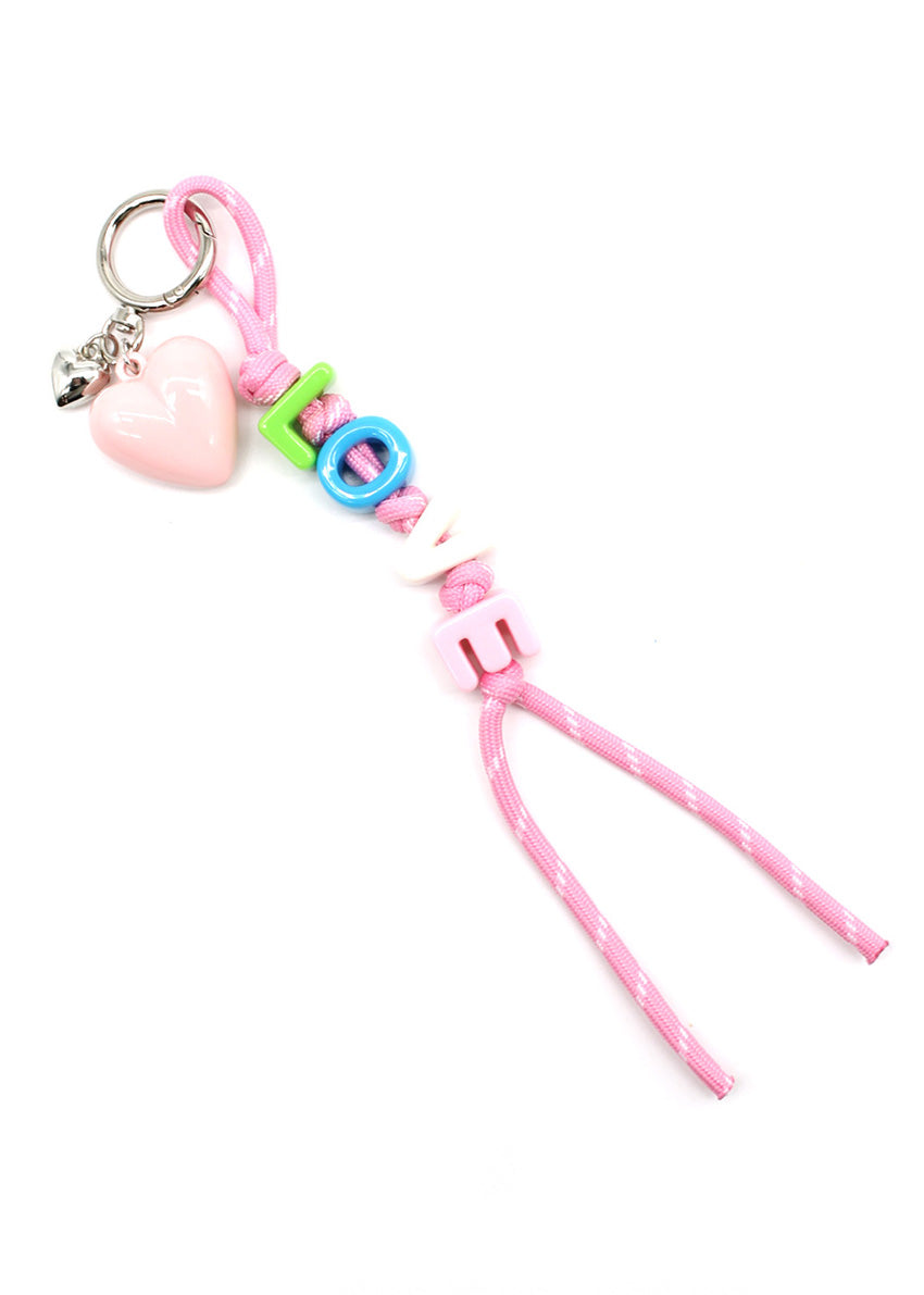 Pink keychain with heart-shaped charm and colorful beads on a white background