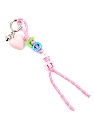 Pink keychain with heart-shaped charm and colorful beads on a white background