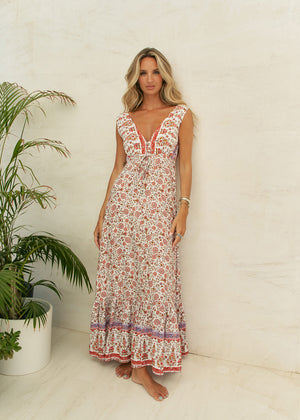 This dress features a timeless classic design, complete with a waist-defining cut and a deep V-neck on both the front and back. Crafted from 100% Rayon, it exudes a sense of effortless style and allure.