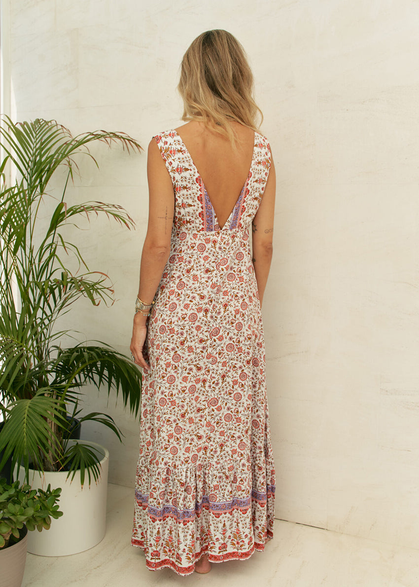 This dress features a timeless classic design, complete with a waist-defining cut and a deep V-neck on both the front and back. Crafted from 100% Rayon, it exudes a sense of effortless style and allure.