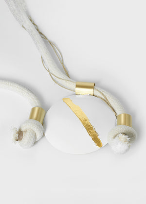 White earbuds with gold accents on a light gray background