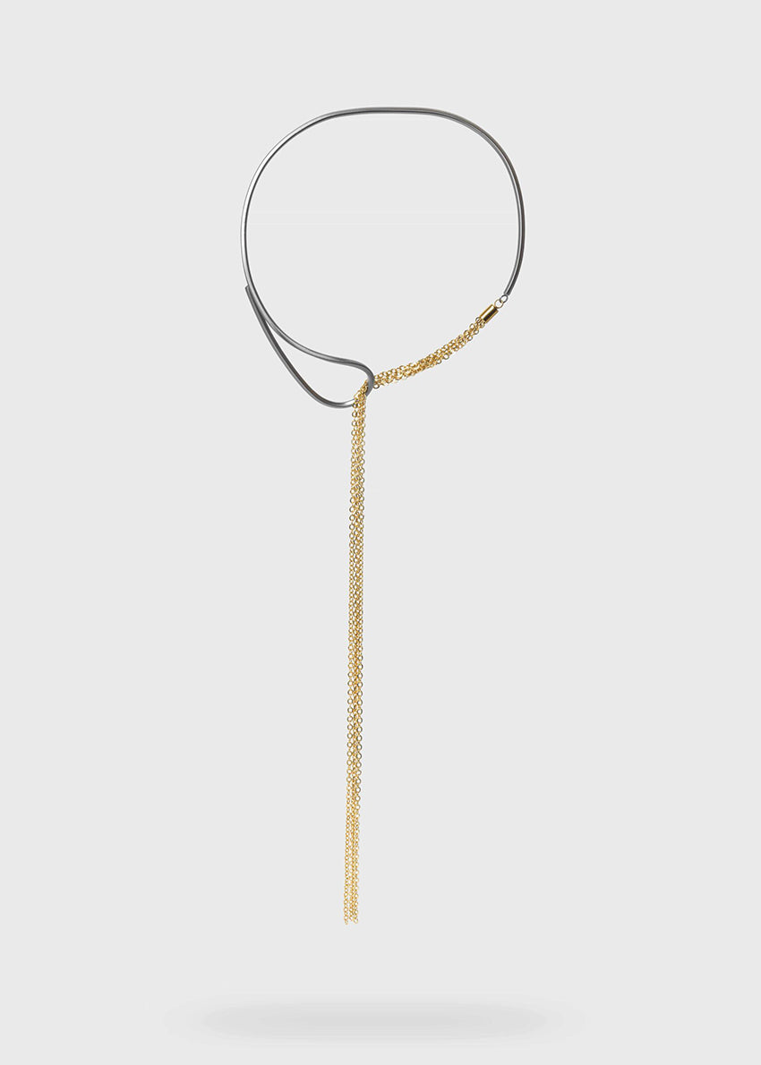 A gold and gun metal plated necklace with a thin metallic rod and a delicate chain.