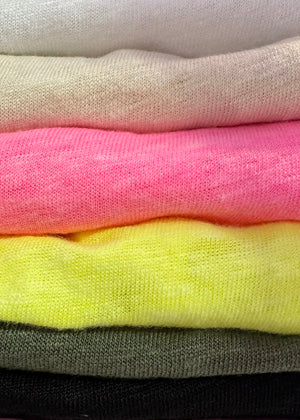 A different colours of sleeveless linen top with a round neckline and front slits