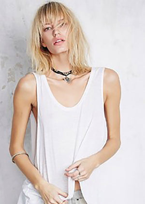 A white sleeveless linen top with a round neckline and front slits
