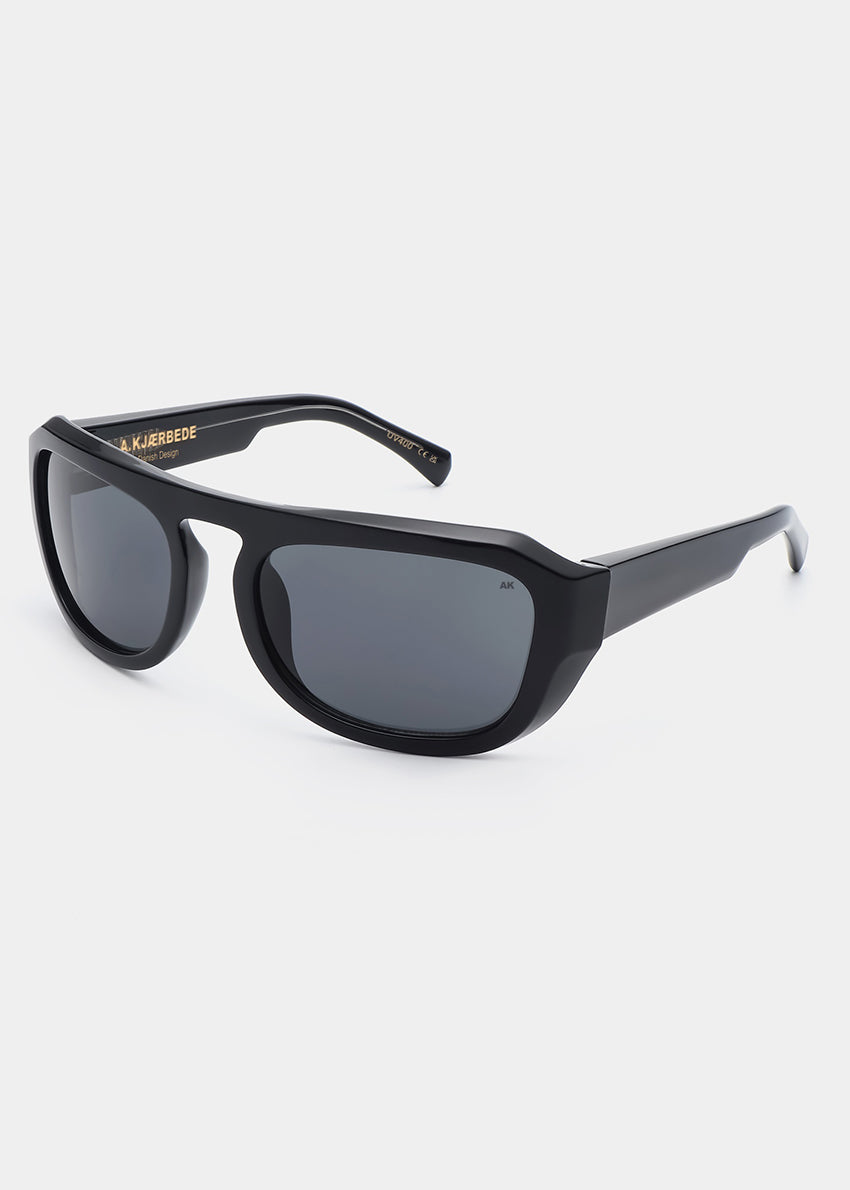 Black sunglasses with gold logo on a white background