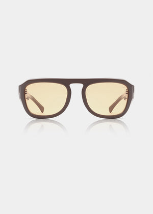 Sunglasses with brown frame and yellow-tinted lenses on a white background