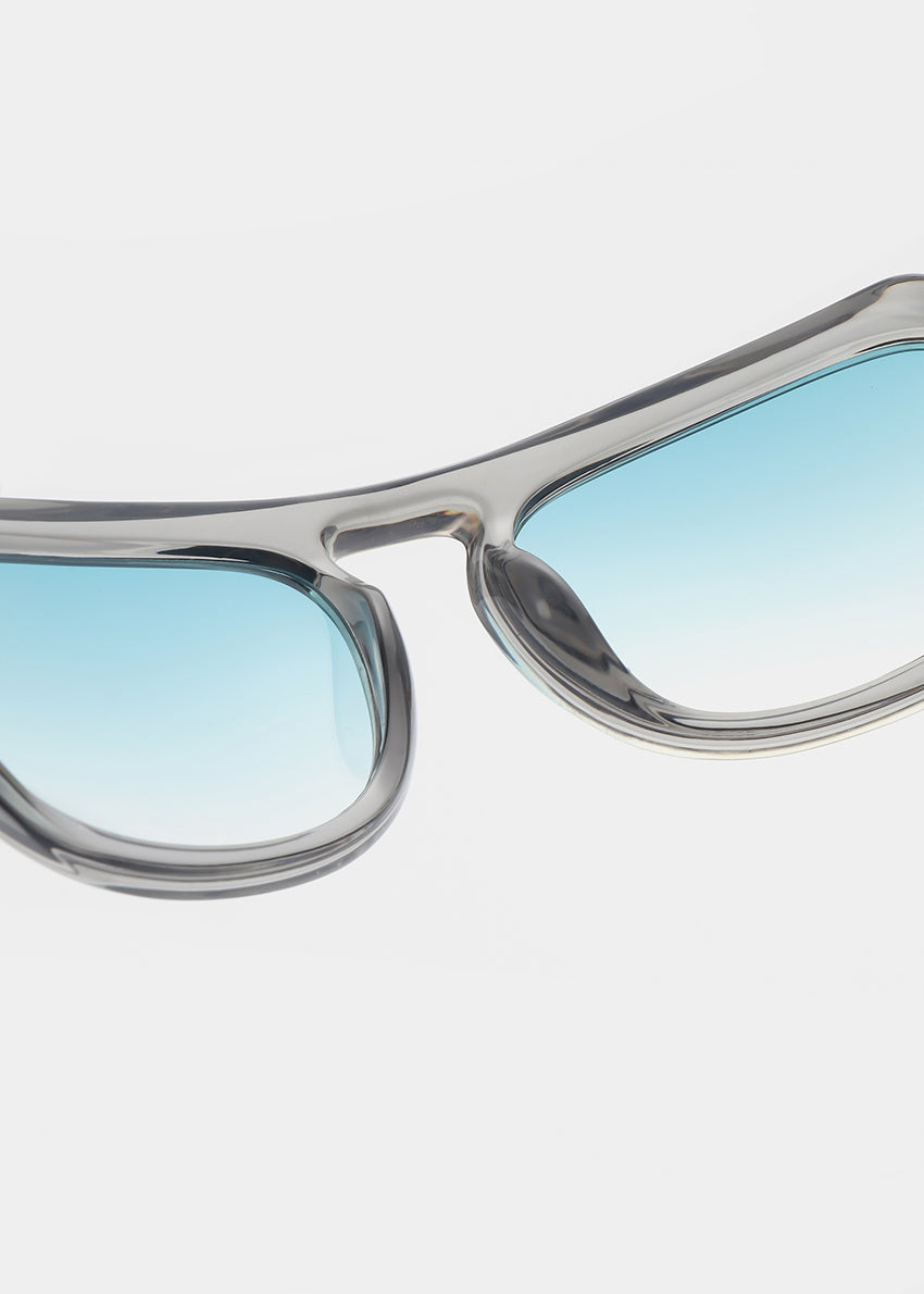 Sunglasses with blue gradient lenses on a light gray background