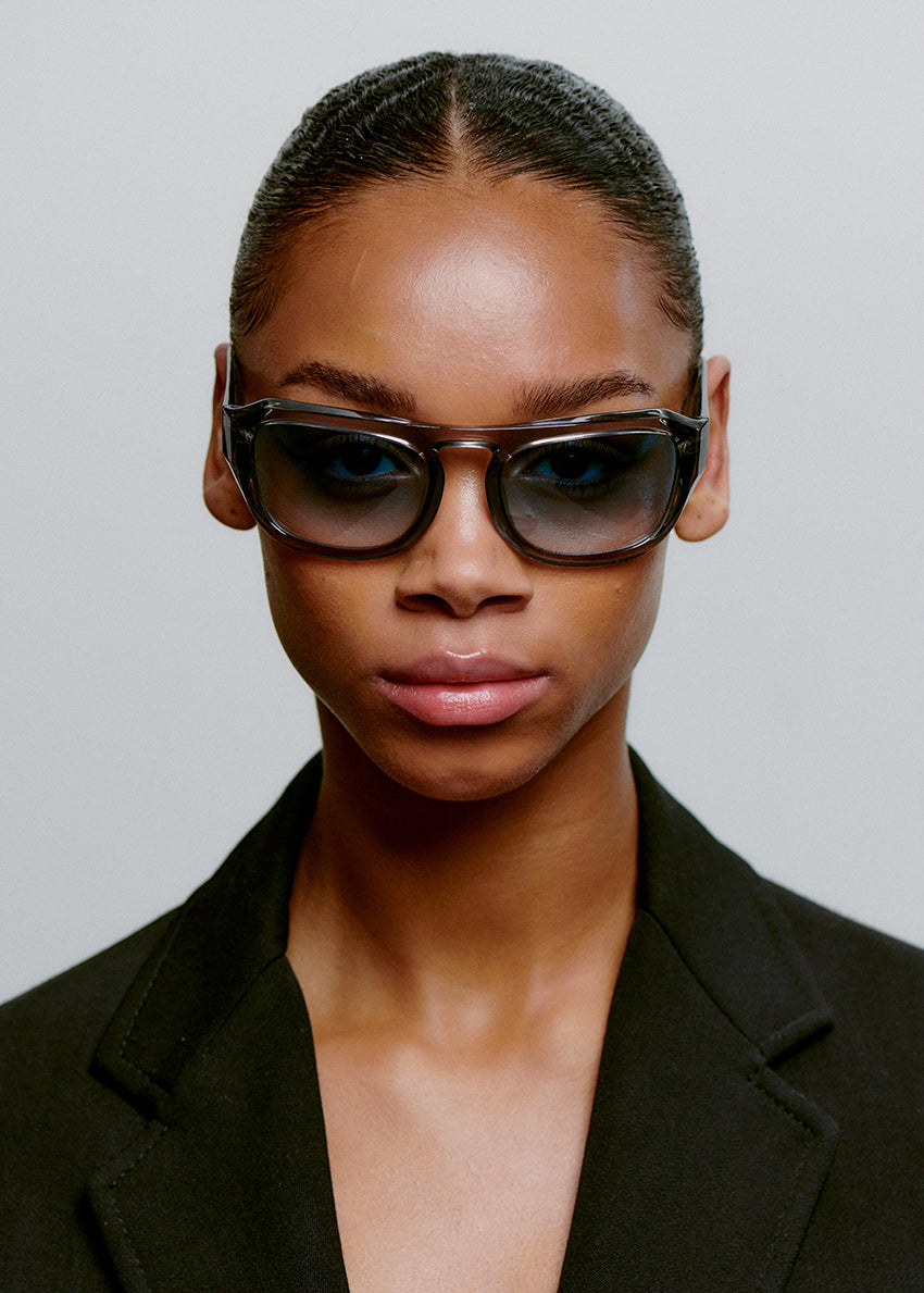 Sunglasses with blue gradient lenses on a white background