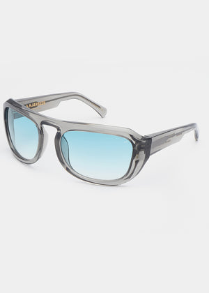 Sunglasses with gray frame and blue gradient lenses on a white background