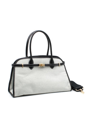 A white canvas Mendocino bag with black details and a gold metallic zipper, displayed against a plain background.