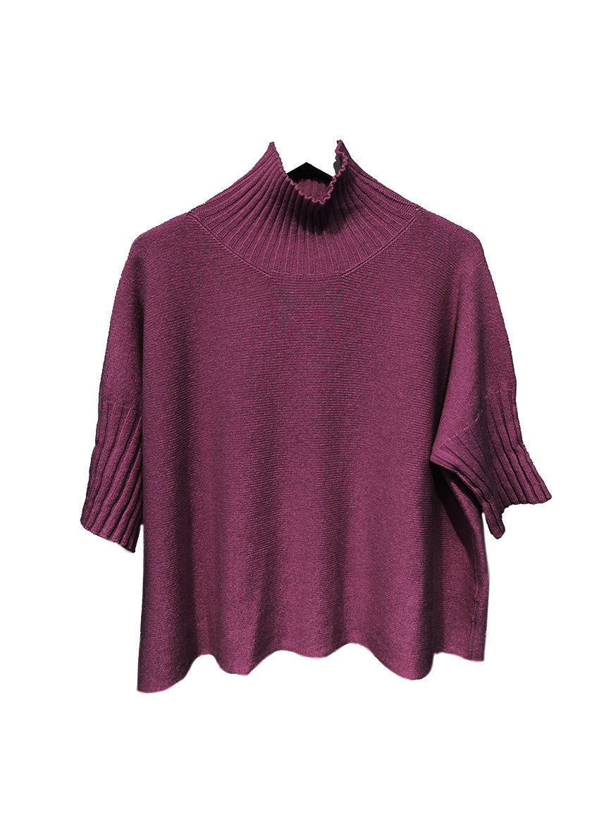 Dark red sweater on a hanger against a white background