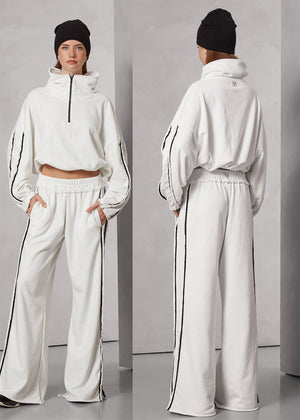 White tracksuit with black stripes worn by a person, shown from front and back on a gray background.