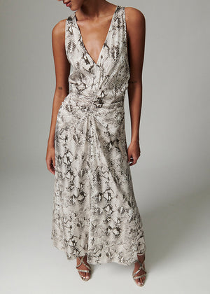 Woman wearing a patterned dress against a neutral background