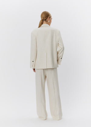 Person wearing a beige suit on a white background