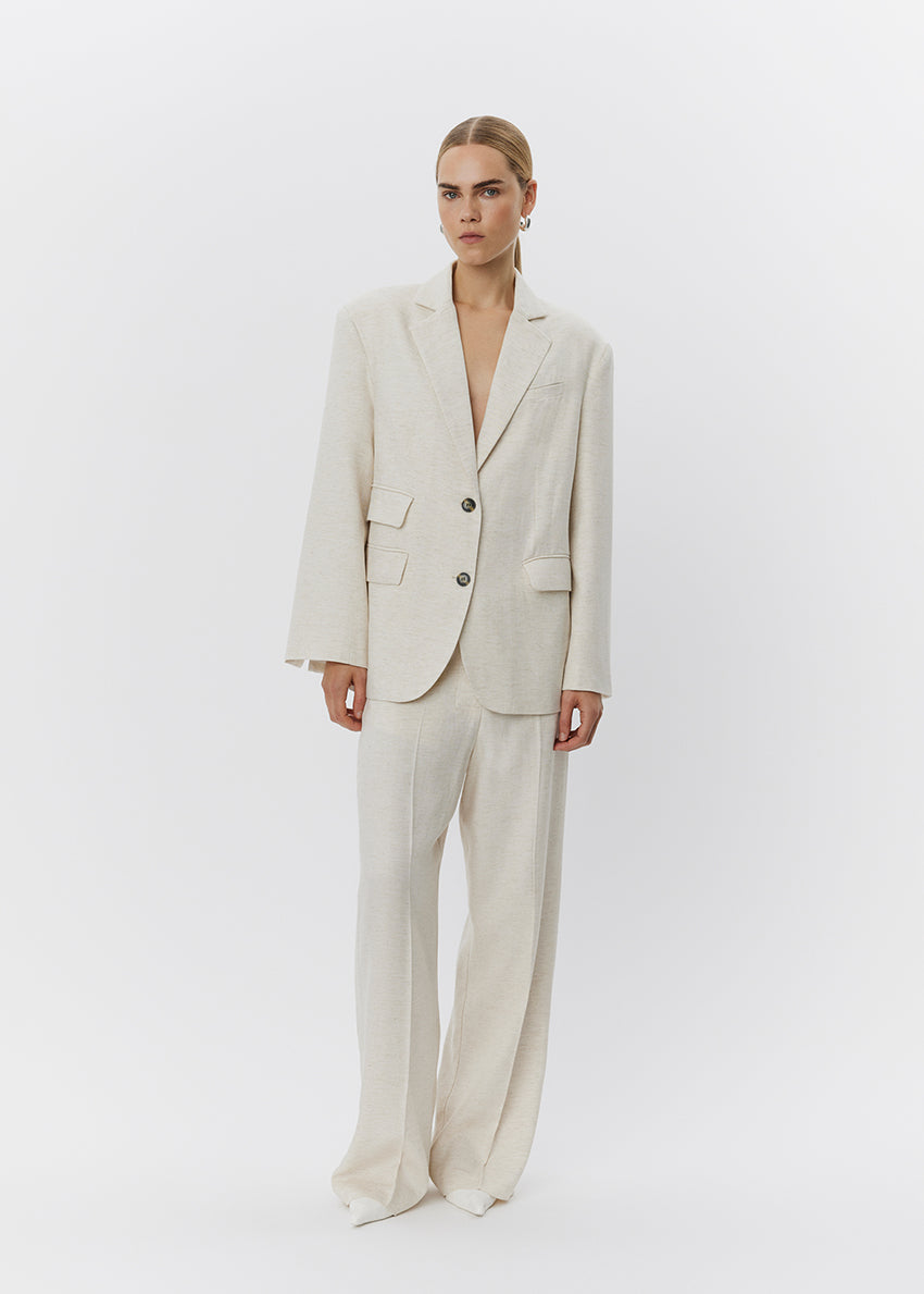 Woman wearing a beige suit on a white background