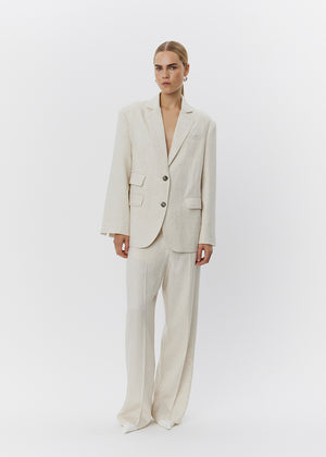 Woman wearing a beige suit on a white background