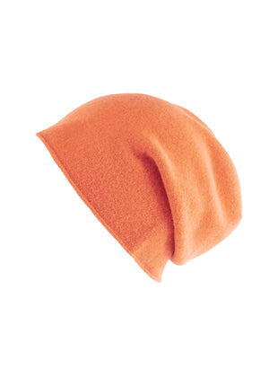 A coral wool beanie on a white background 