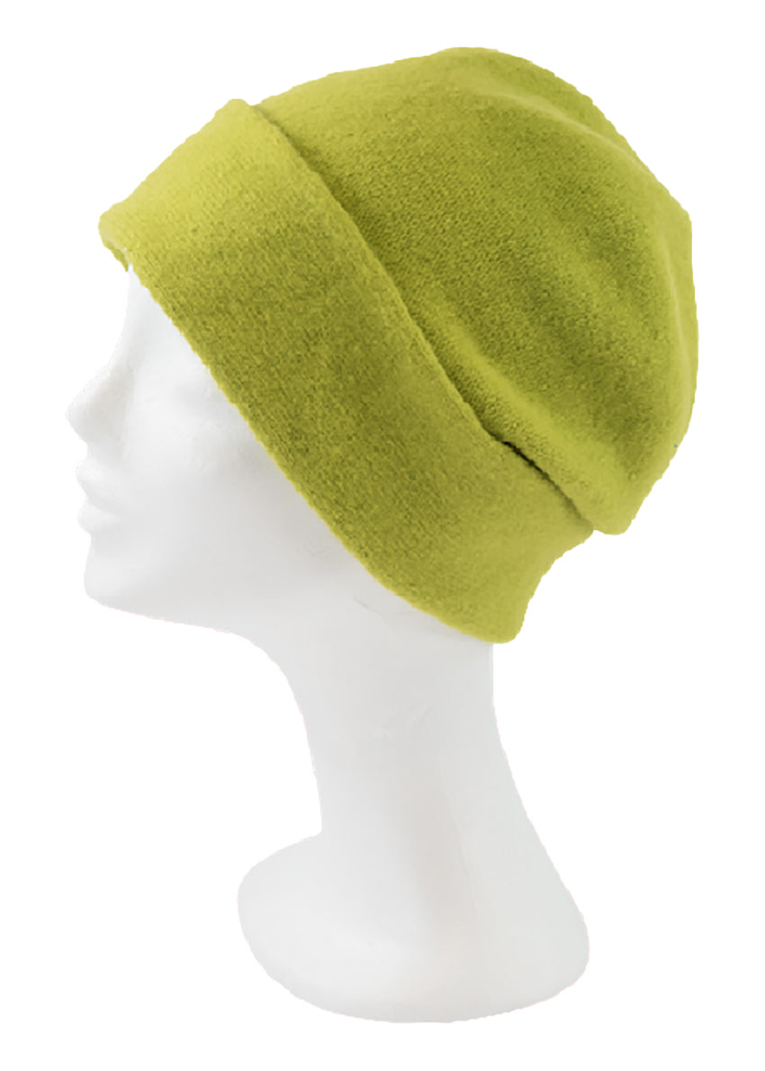 A green yellow wool beanie on a white background 