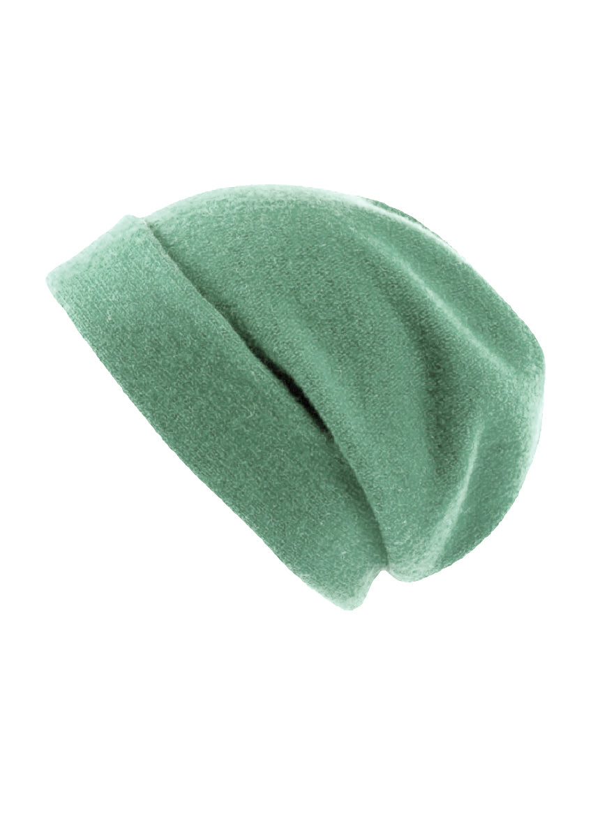 A light green wool beanie on a white background 