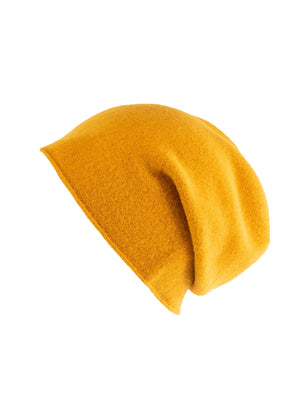 A yellow wool beanie on a white background 