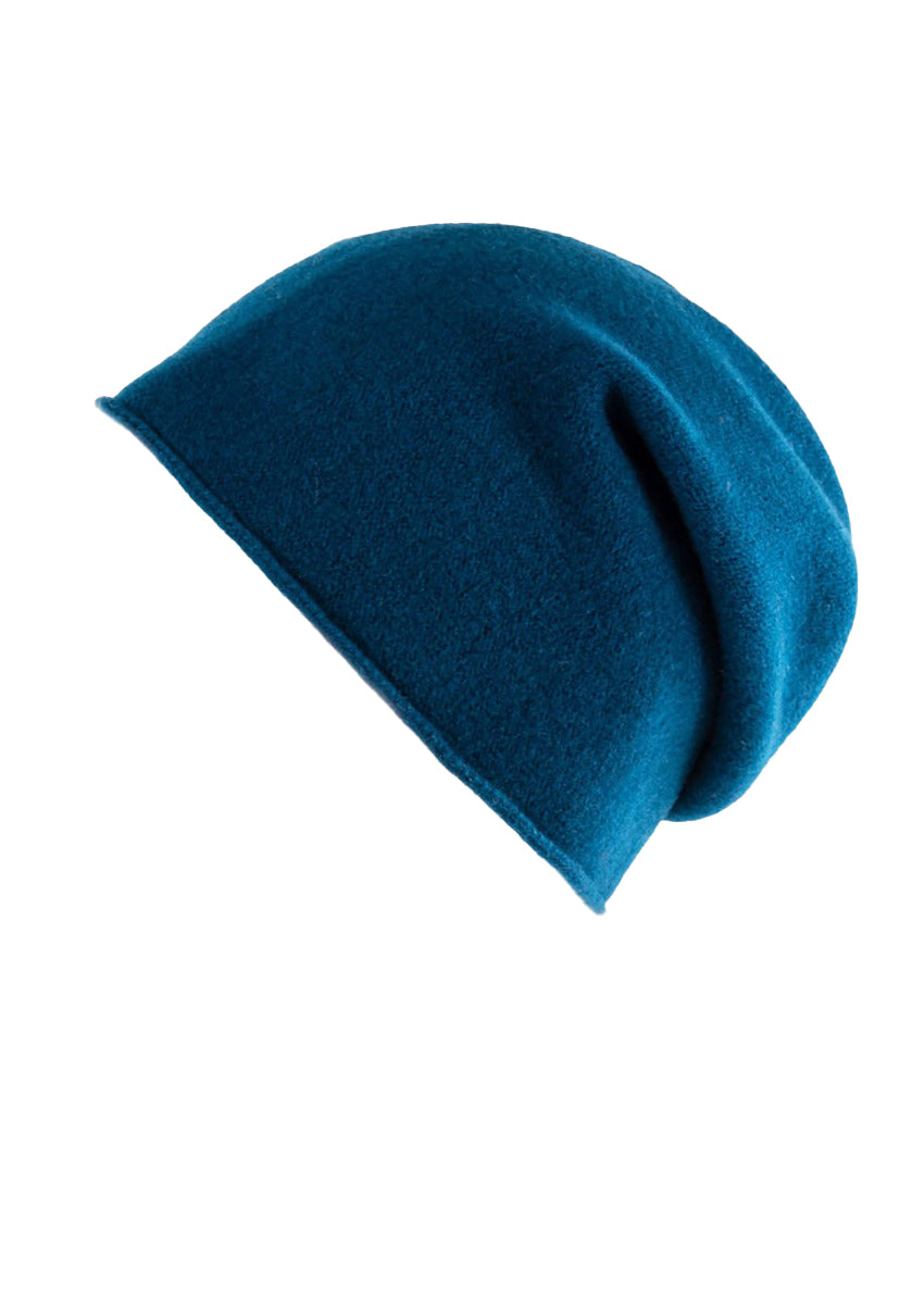 A blue wool beanie on a white background 