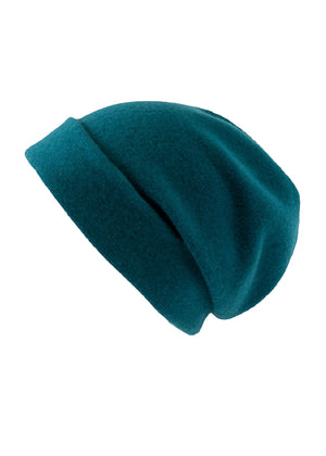 A teal dark wool beanie on a white background 