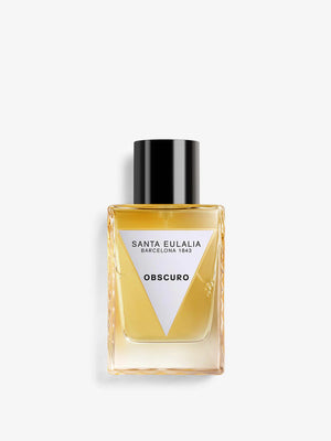 A bottle of Santa Eulalia Obscuro perfume with a clear label and a black cap, containing a woody spicy fragrance.