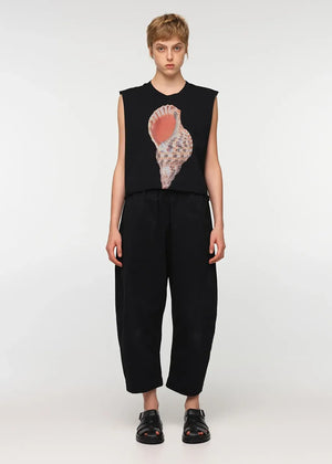 Unisex, mid-length black trousers, made from soft, non-stretch rayon fabric, in a relaxed, organic cut, featuring a wide elastic waistband, a dropped crotch, and front pockets