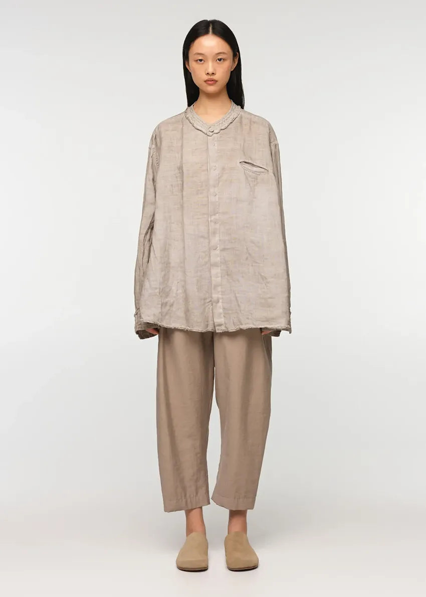 Unisex, mid-length tan trousers, made from soft, non-stretch rayon fabric, in a relaxed, organic cut, featuring a wide elastic waistband, a dropped crotch, and front pockets