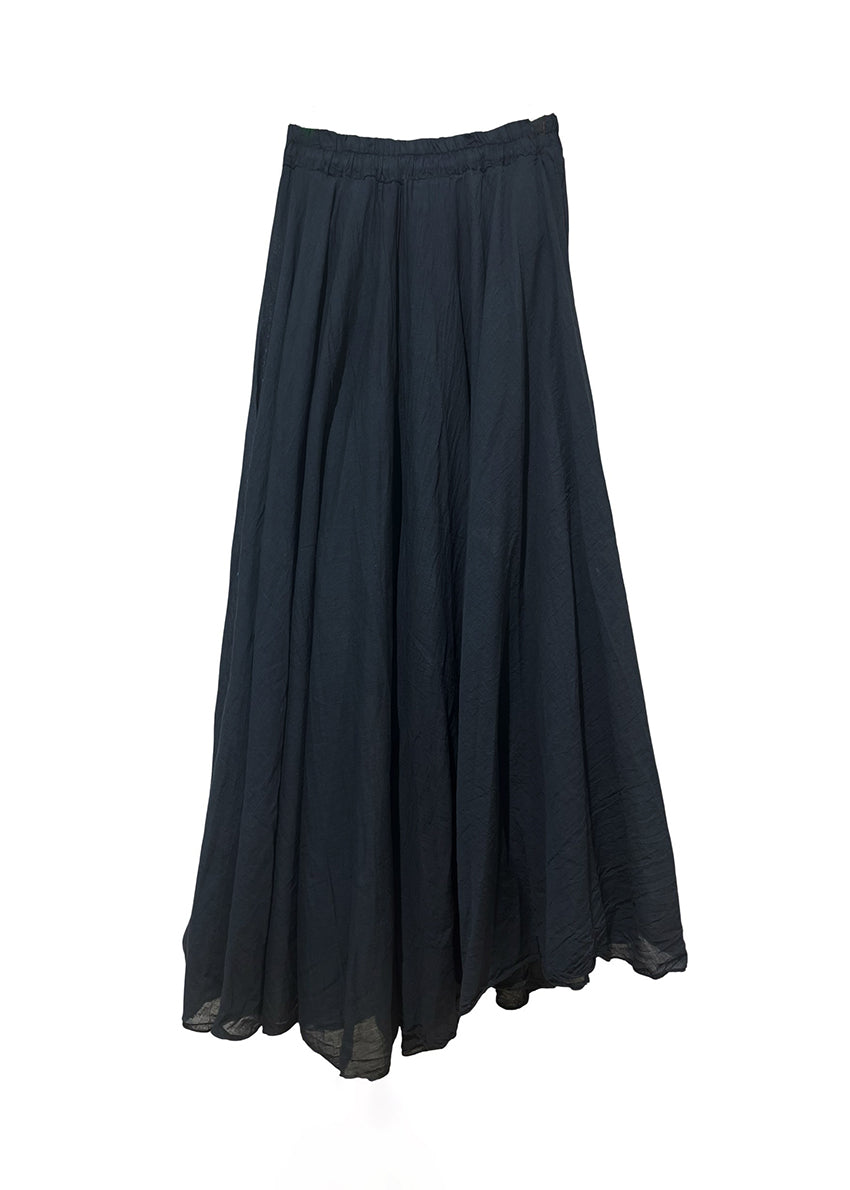 Woman wearing a black denim vest over a black skirt on a white background