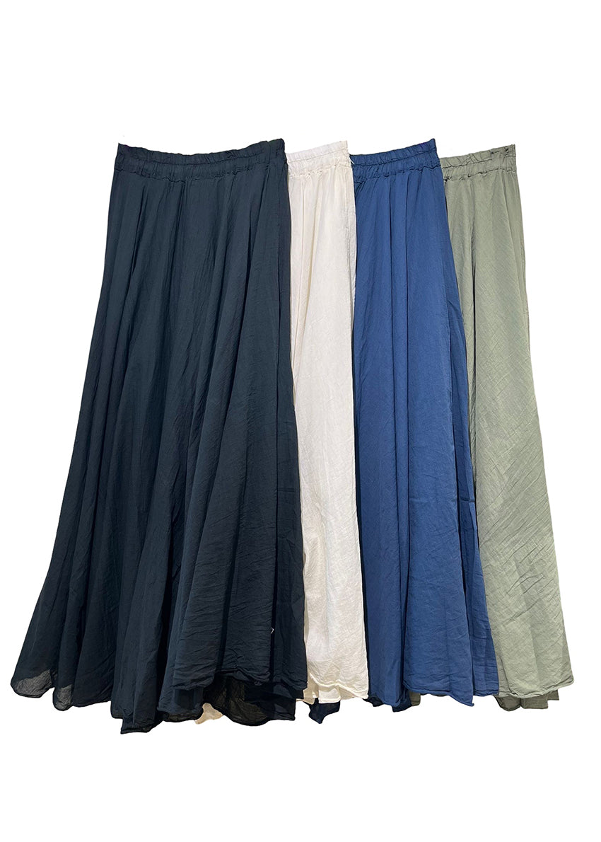Four long skirts in black, white, blue, and green on a white background