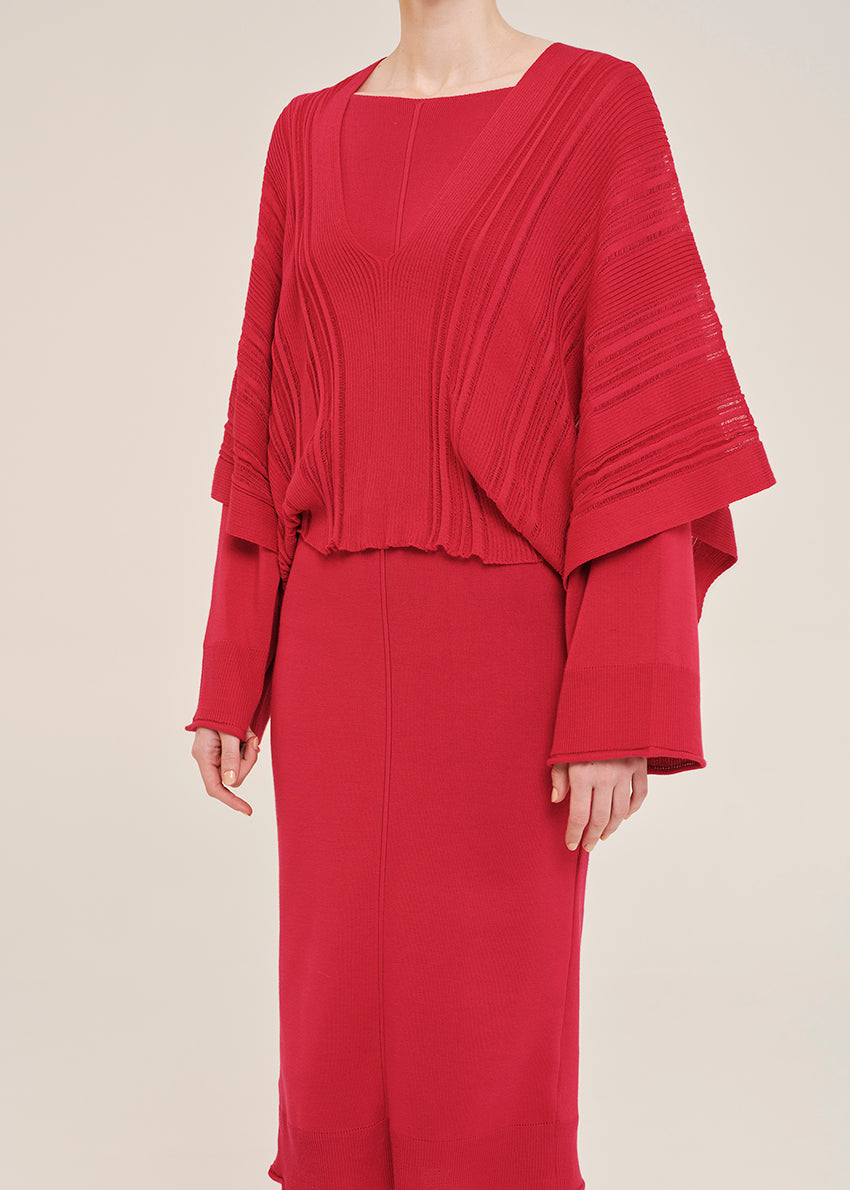 Red dress with a layered design on a beige background