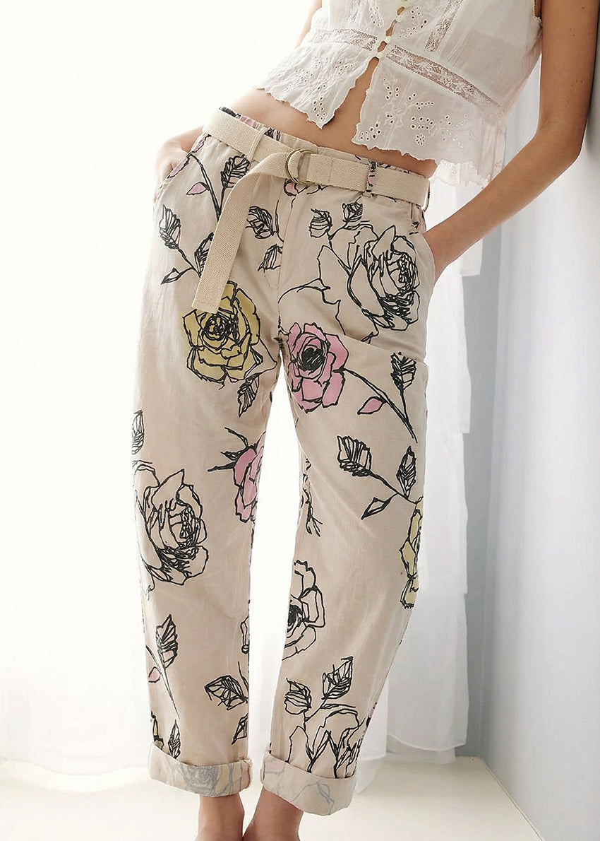 Floral-patterned pants worn by a person on a white background