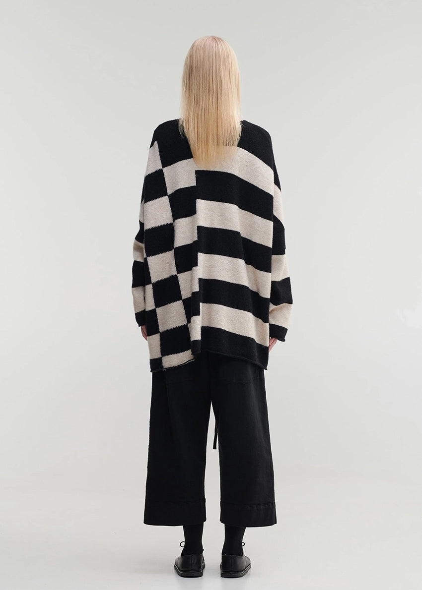 Knitted unisex oversized top in a fluffy yarn blend with a round neckline, designed for a relaxed fit and versatile styling.