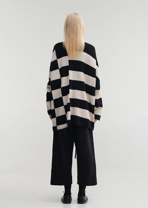 Knitted unisex oversized top in a fluffy yarn blend with a round neckline, designed for a relaxed fit and versatile styling.