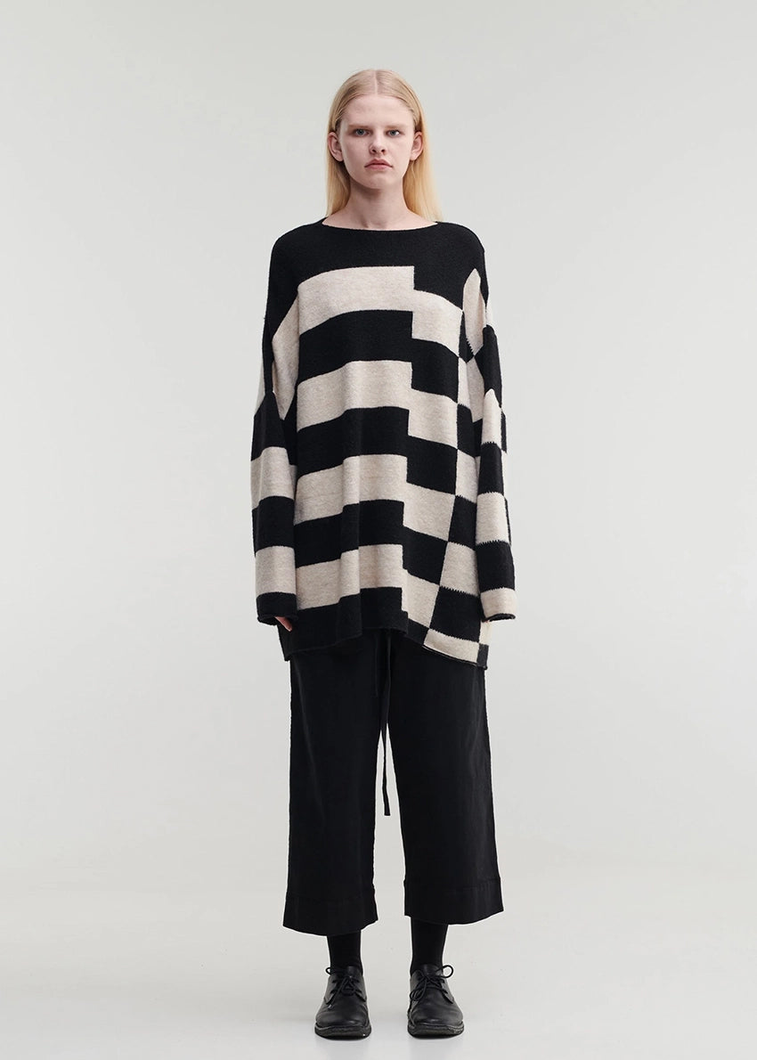 Knitted unisex oversized top in a fluffy yarn blend with a round neckline, designed for a relaxed fit and versatile styling.