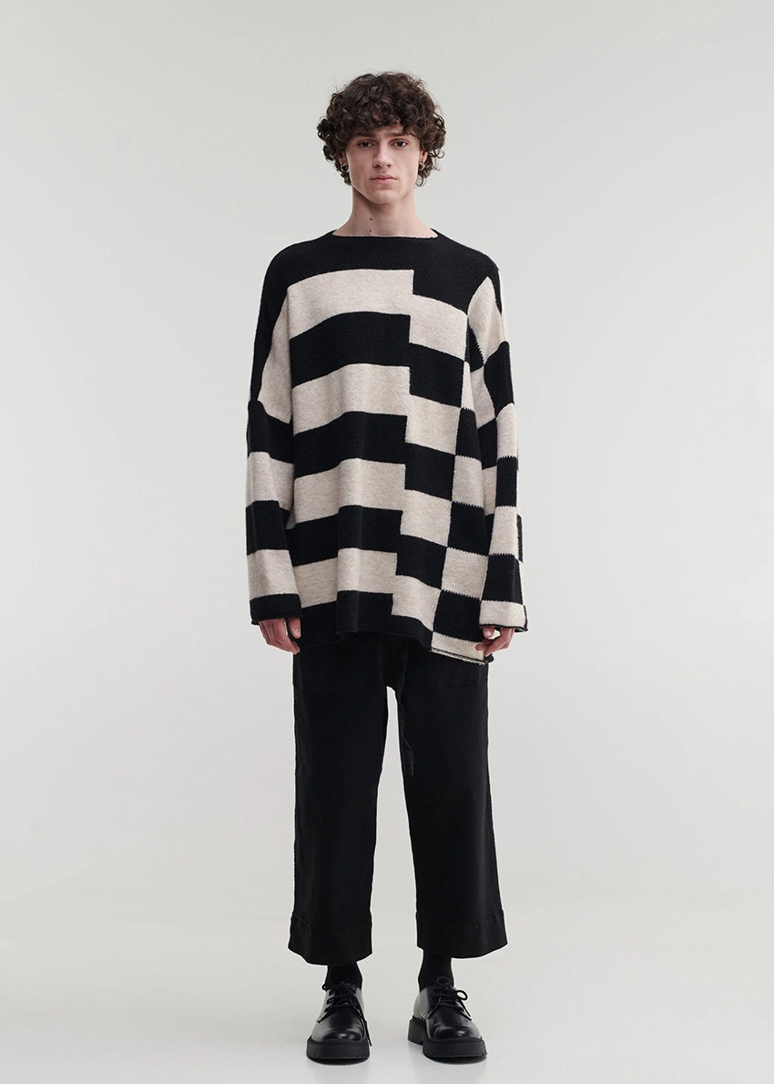 Knitted unisex oversized top in a fluffy yarn blend with a round neckline, designed for a relaxed fit and versatile styling.