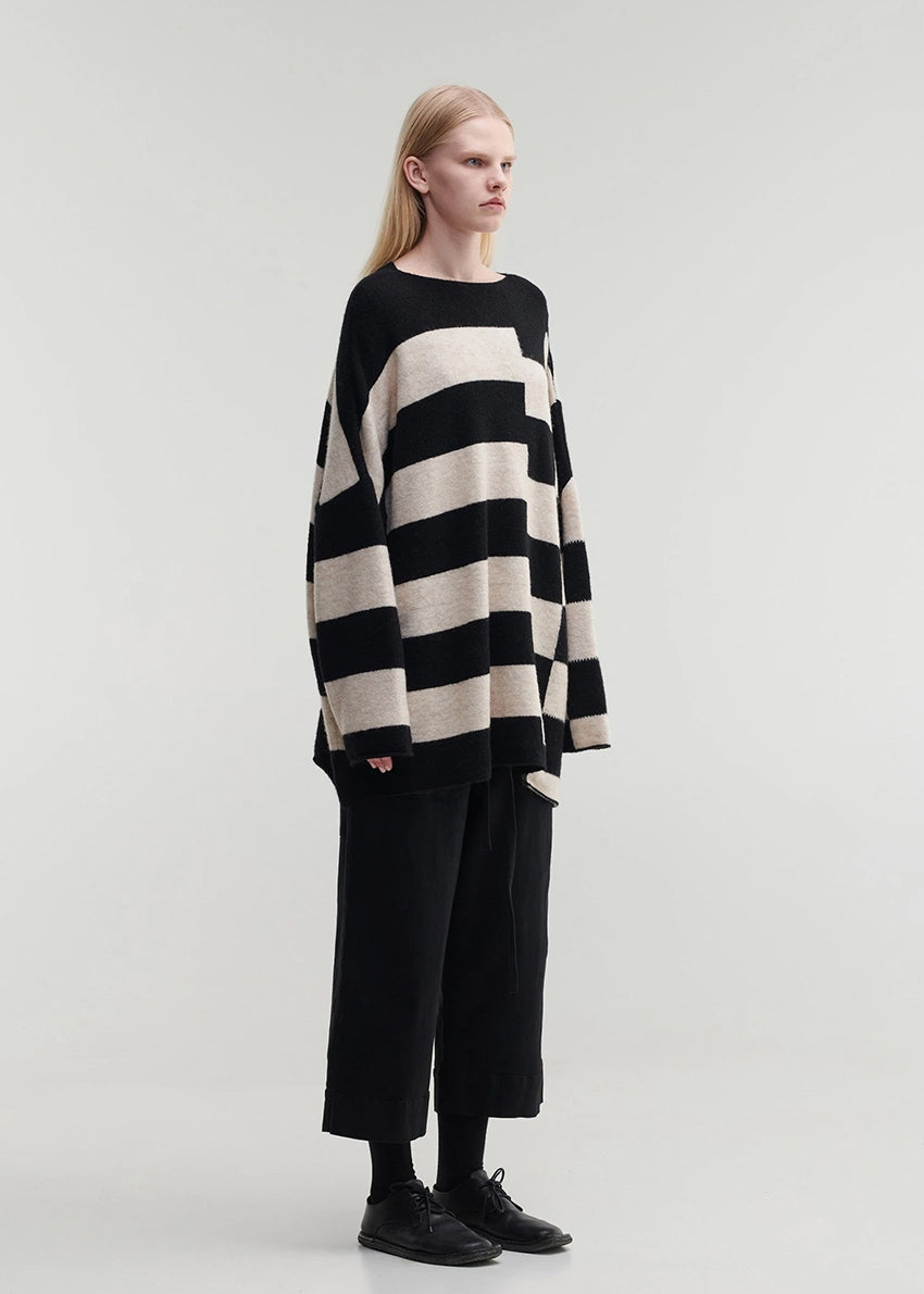 Knitted unisex oversized top in a fluffy yarn blend with a round neckline, designed for a relaxed fit and versatile styling.