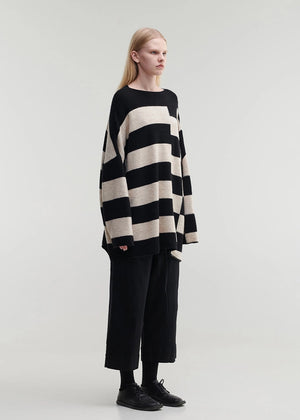 Knitted unisex oversized top in a fluffy yarn blend with a round neckline, designed for a relaxed fit and versatile styling.