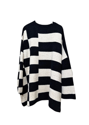 Knitted unisex oversized top in a fluffy yarn blend with a round neckline, designed for a relaxed fit and versatile styling.