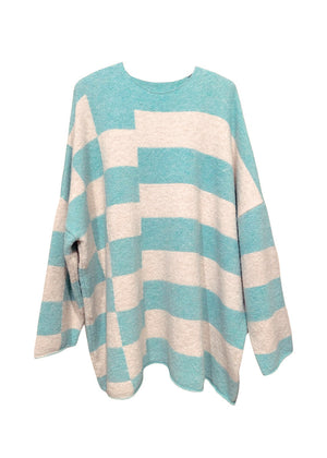 Knitted unisex oversized top in a fluffy yarn blend with a round neckline, designed for a relaxed fit and versatile styling.