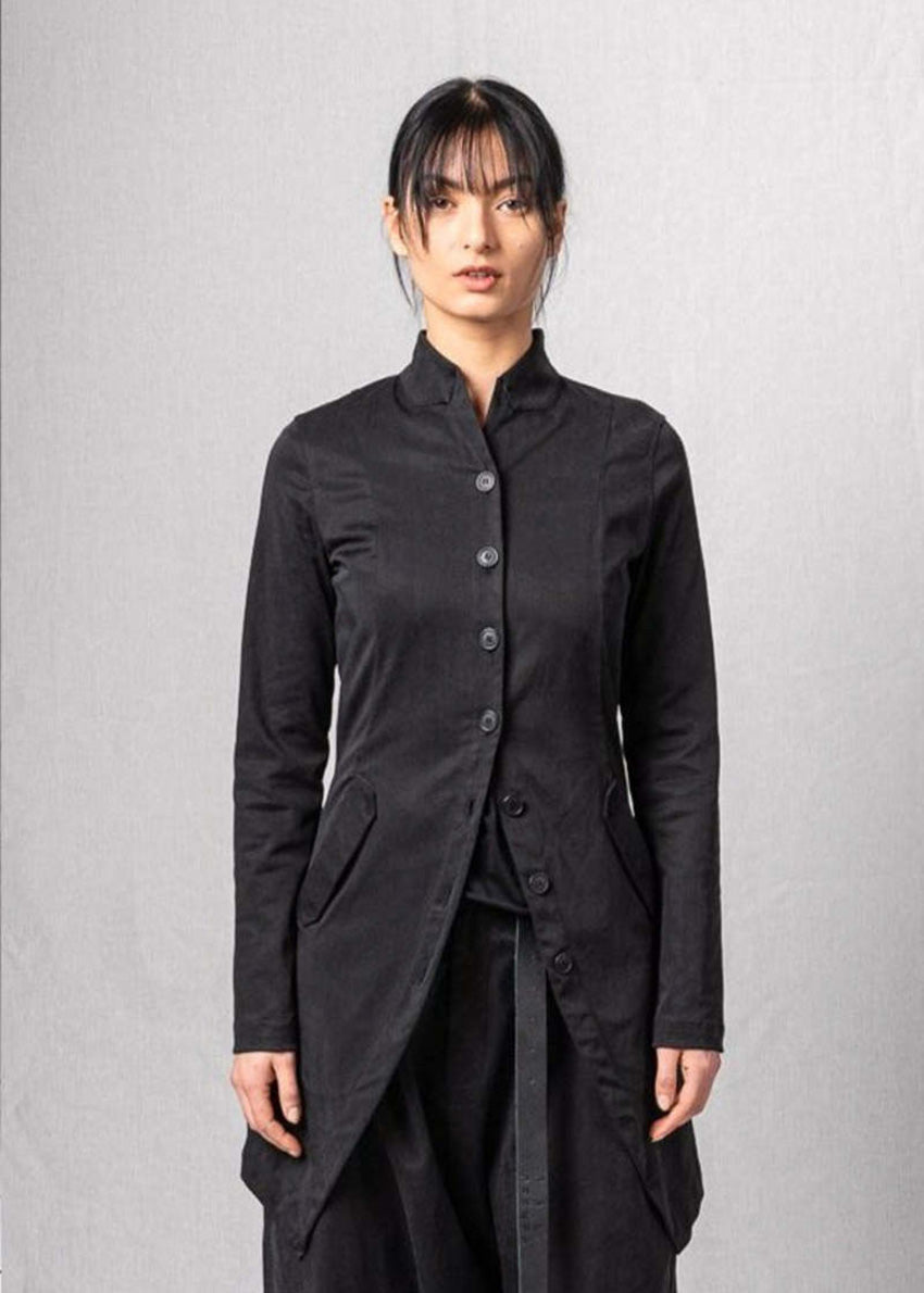 Person wearing a black coat on a plain background