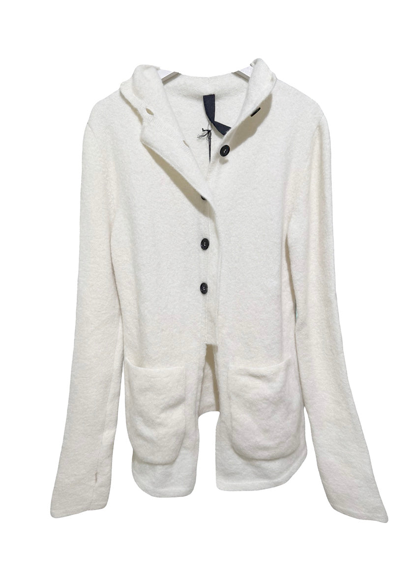 Person wearing a white jacket and beanie on a plain background