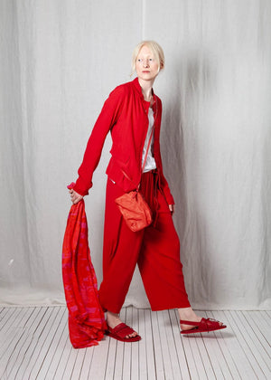 Person wearing a red outfit with a white background