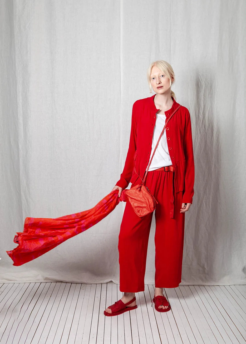 Person wearing a red outfit with a white background