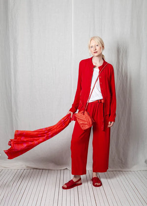 Person wearing a red outfit with a white background