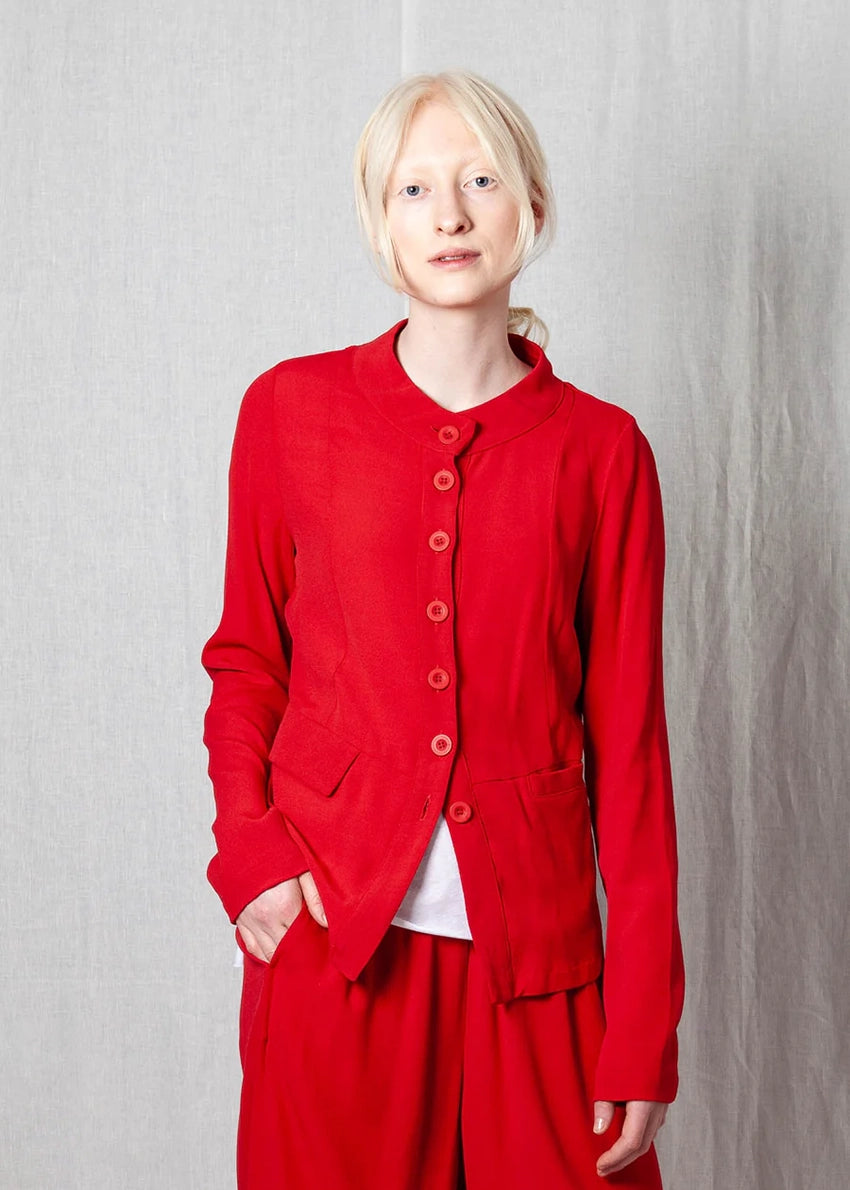 Person wearing a red outfit against a plain background