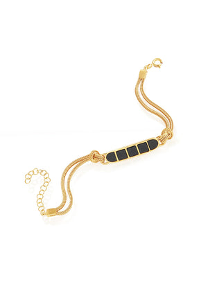 Gold bracelet with black stones on a white background