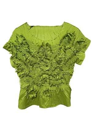 A yellow-green top with a textured floral design and a elasticated waist.